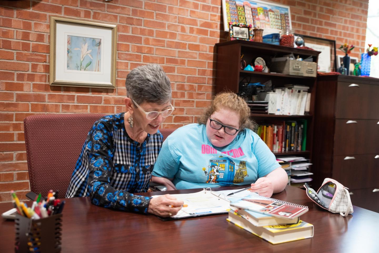 Betty Curry works with a student in the Tiger Learning Commons