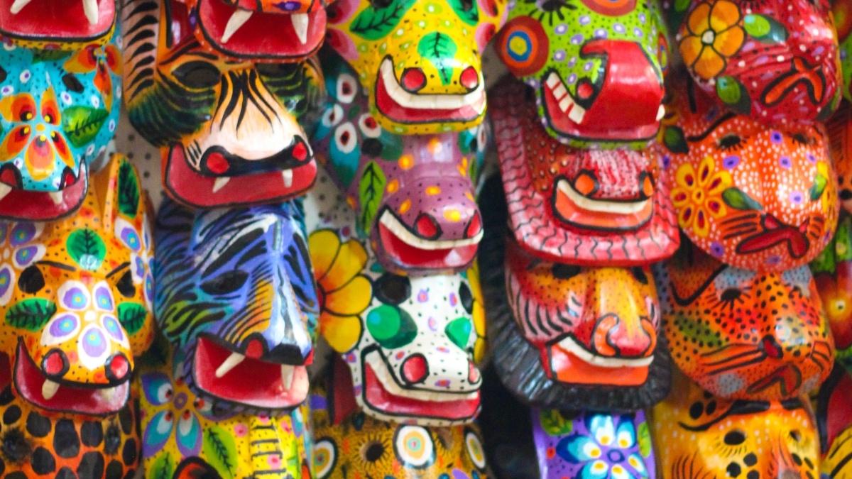 Various colorful masks hanging on a wall