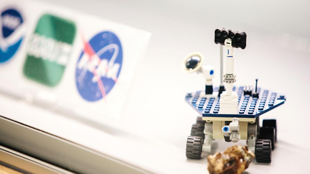 model of nasa rover with nasa logo in background